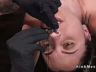 Slave bent over strapped with hair pulled back